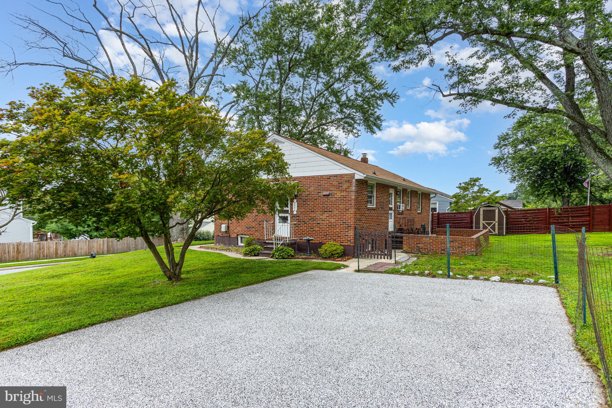 4234 Necker Avenue Baltimore, MD 21236 - Photo 24 of 29 a view of a house with a big yard and large trees