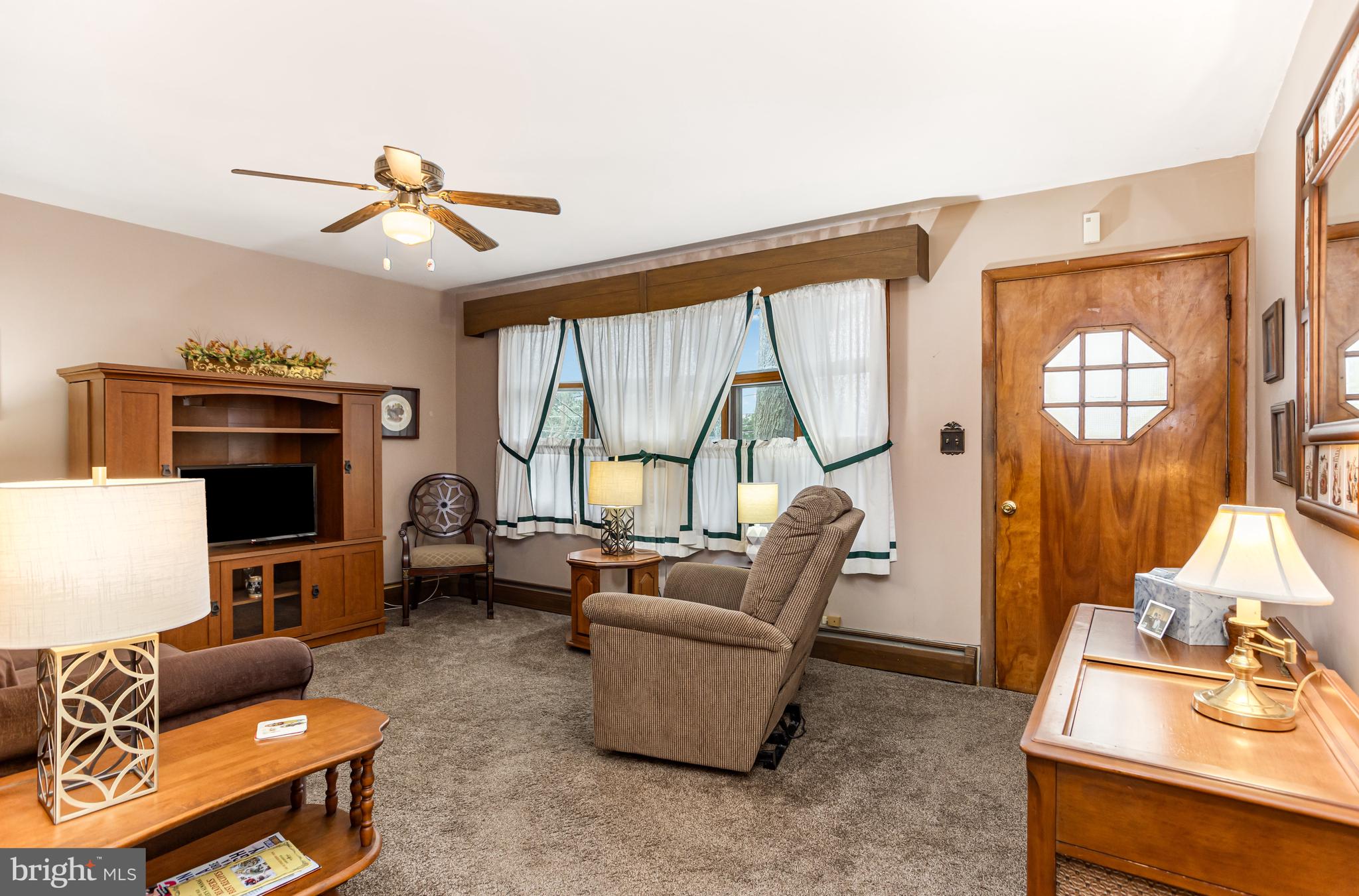 4234 Necker Avenue Baltimore, MD 21236 - Photo 3 of 29 a living room with furniture a flat screen tv and a large window