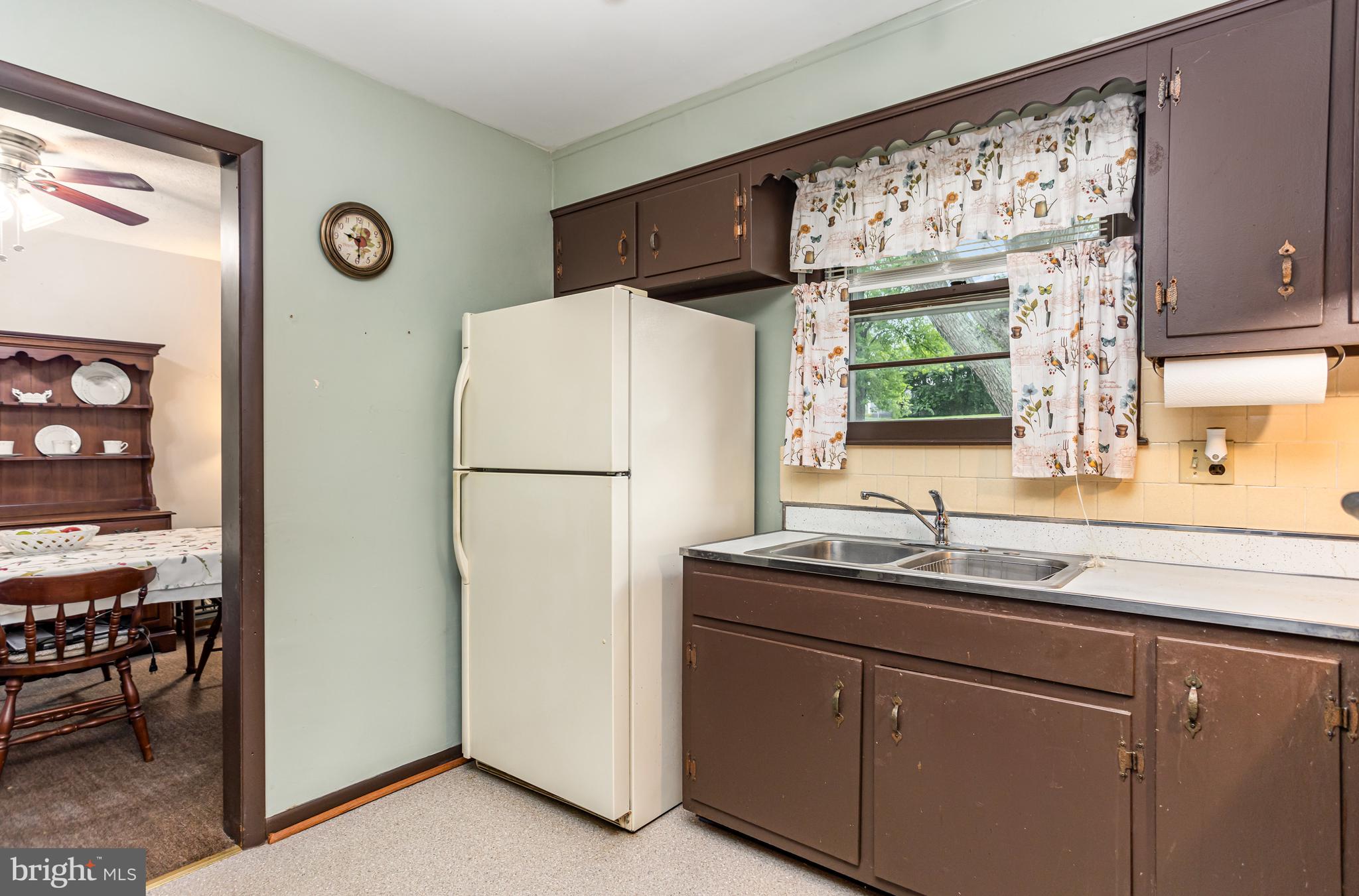 4234 Necker Avenue Baltimore, MD 21236 - Photo 7 of 29 a kitchen with a refrigerator sink and cabinets