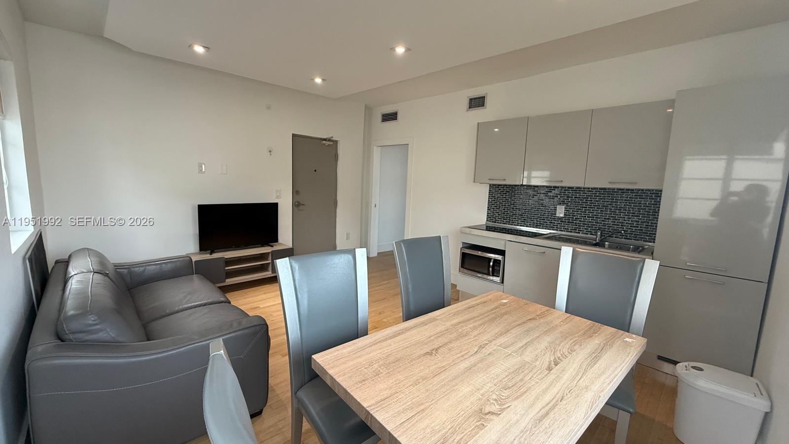 600 15th Street, Unit 9 Miami Beach, FL 33139 - Photo 1 of 12 a living room with furniture and a flat screen tv