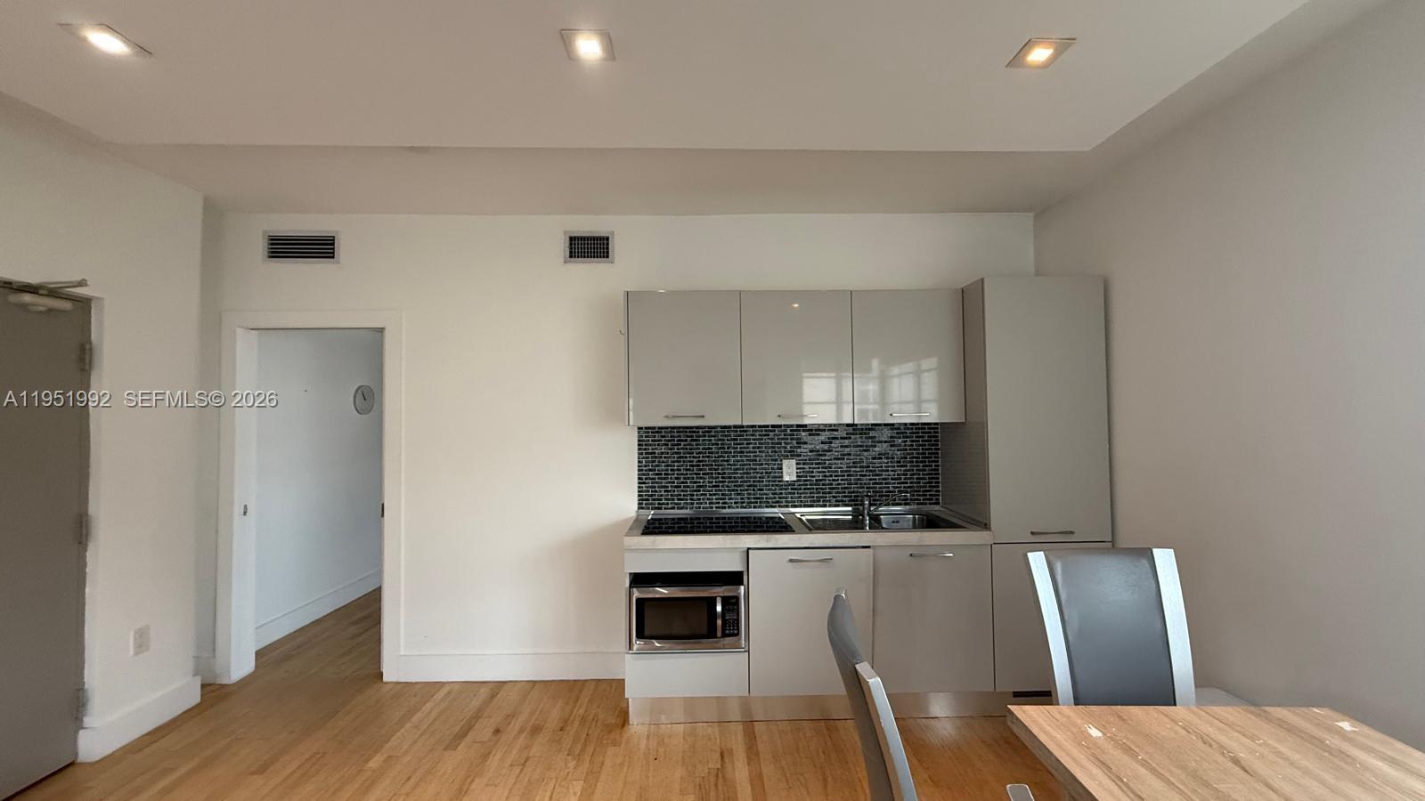 600 15th Street, Unit 9 Miami Beach, FL 33139 - Photo 3 of 12 a living room with furniture and a fireplace