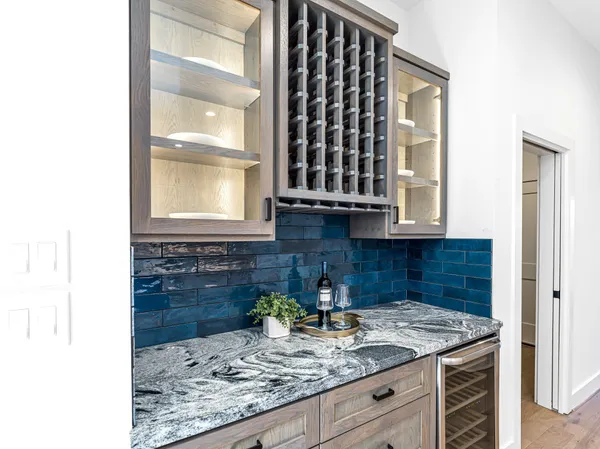 a kitchen with a granite countertop sink and cabinets