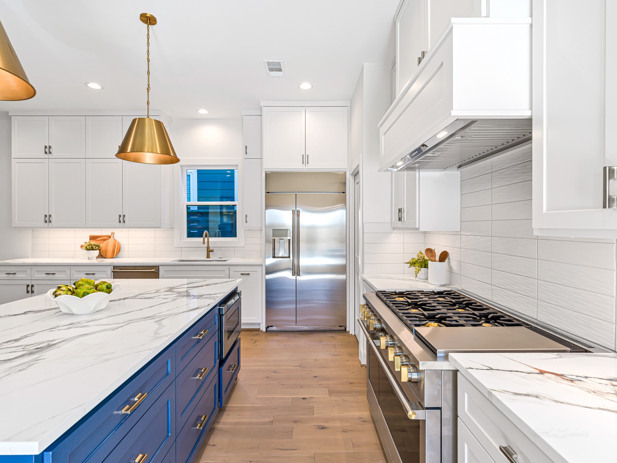 1207 Tabor Street Houston, TX 77009 - Photo 16 of 46 a kitchen that has a lot of cabinets in it and wooden floors