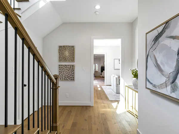 a view of a hallway view with wooden floor and staircase