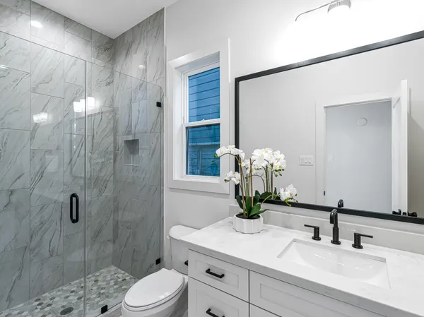 a bathroom with a sink a toilet and shower