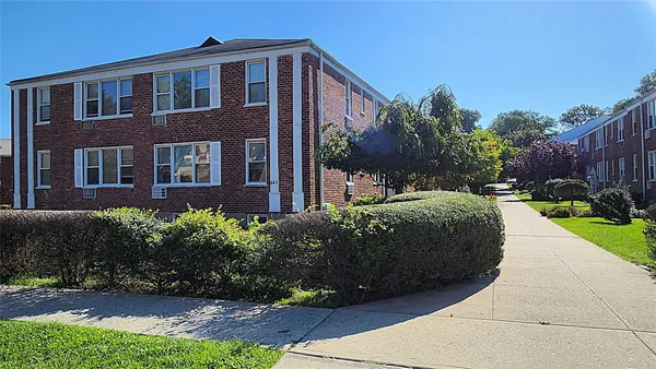a view of a brick house with a yard