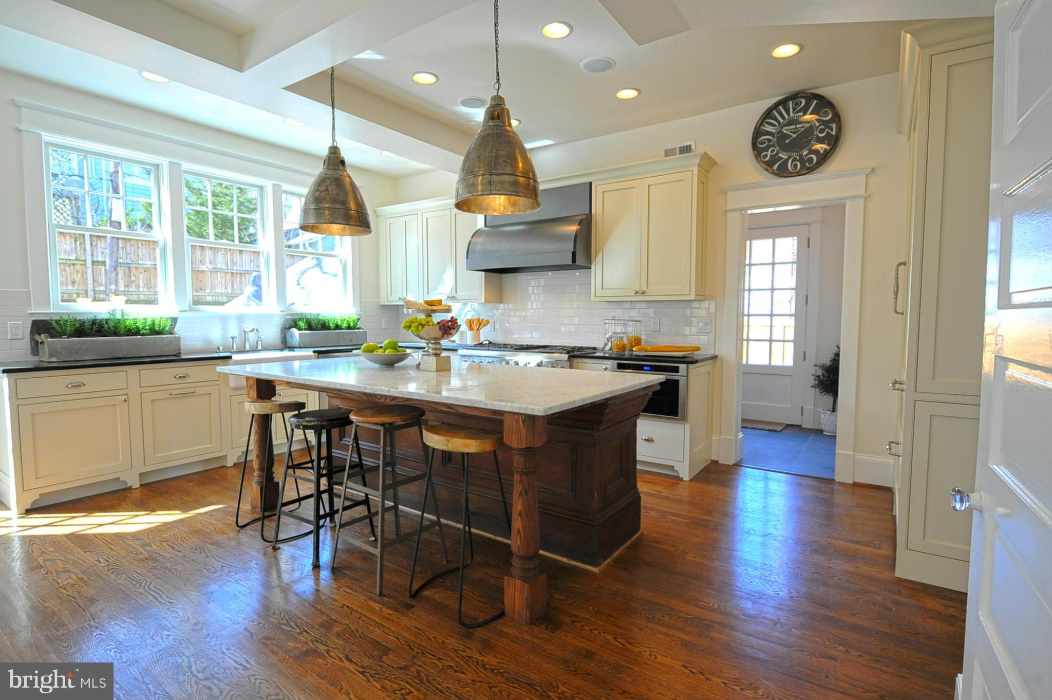 3816 Military Road Northwest Washington, DC 20015 - Photo 8 of 22 a kitchen with stainless steel appliances granite countertop wooden floors and sink