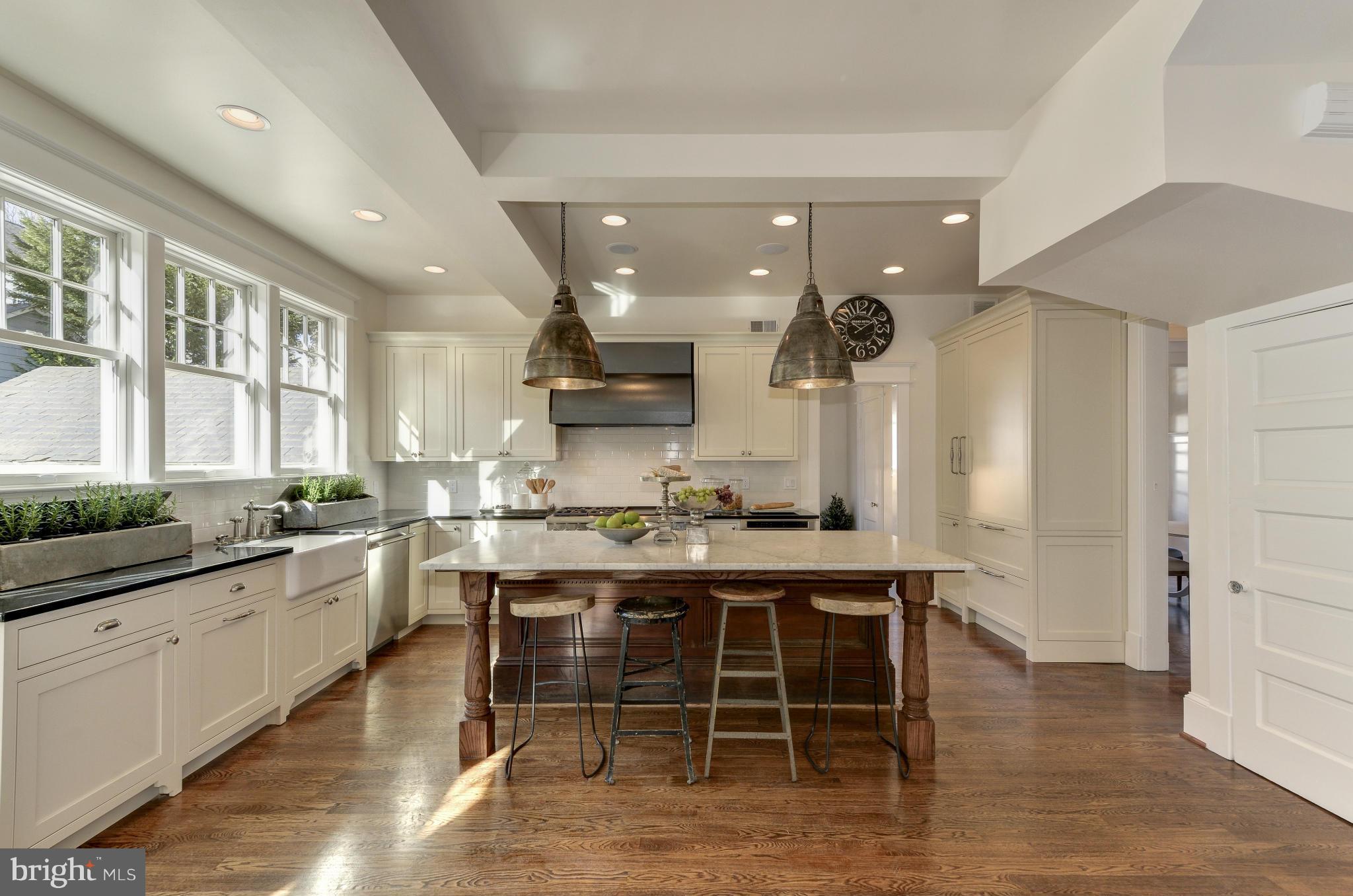 3816 Military Road Northwest Washington, DC 20015 - Photo 9 of 22 a large kitchen with a table and chairs in it