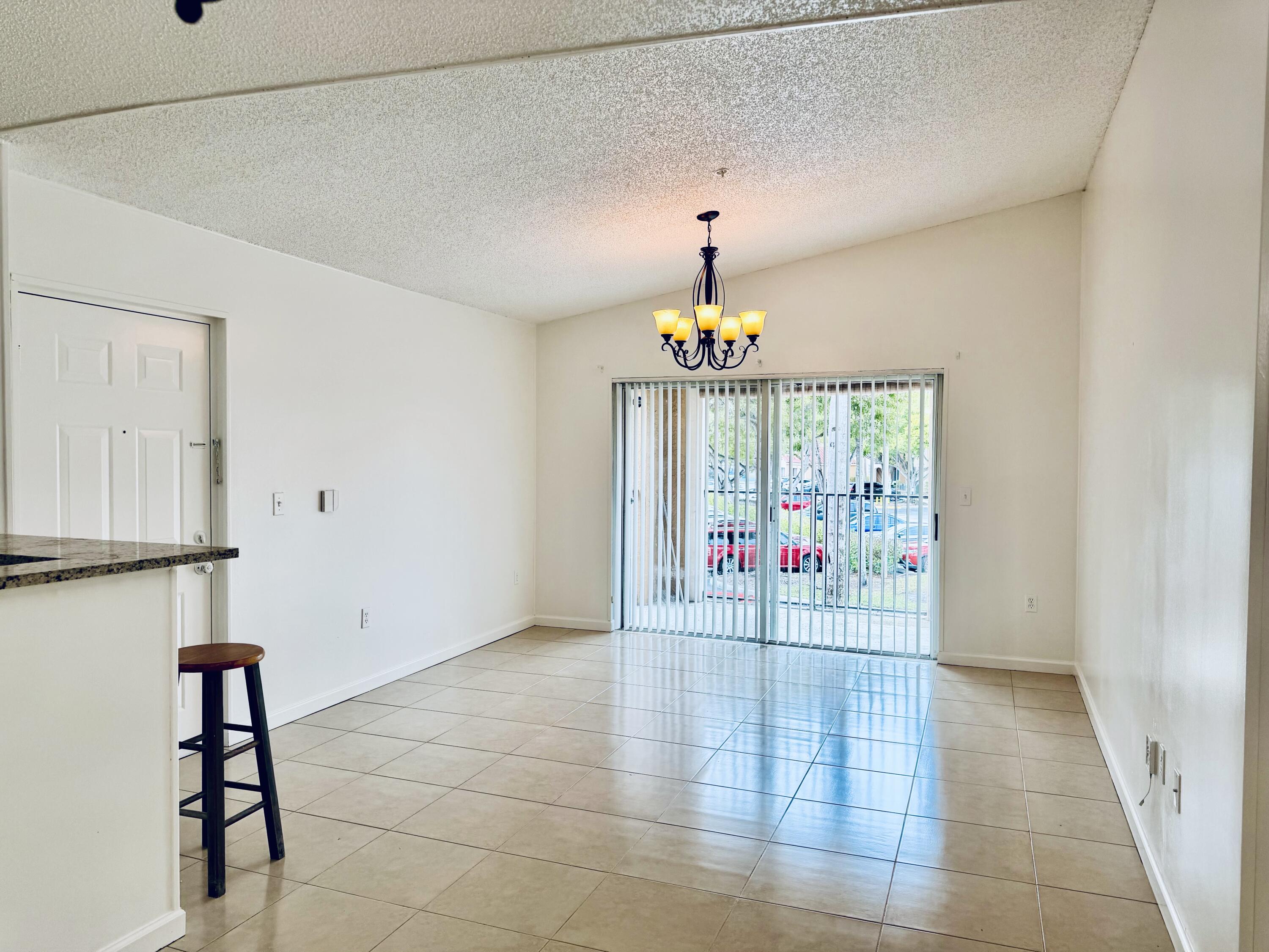 2041 Renaissance Boulevard, Unit 207 Miramar, FL 33025 - Photo 7 of 11 a view of an empty room with a window