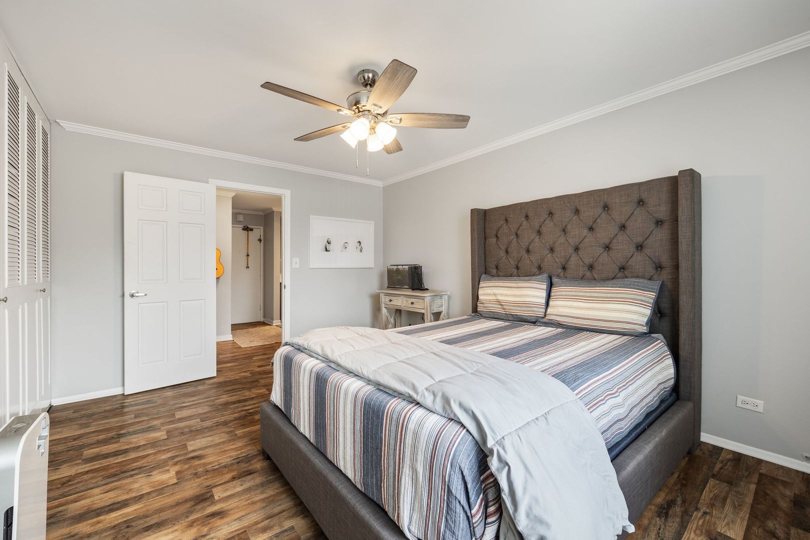 1127 South Old Wilke Road, Unit 203 Rolling Meadows, IL 60005 - Photo 12 of 13 a bedroom with a bed and a chandelier