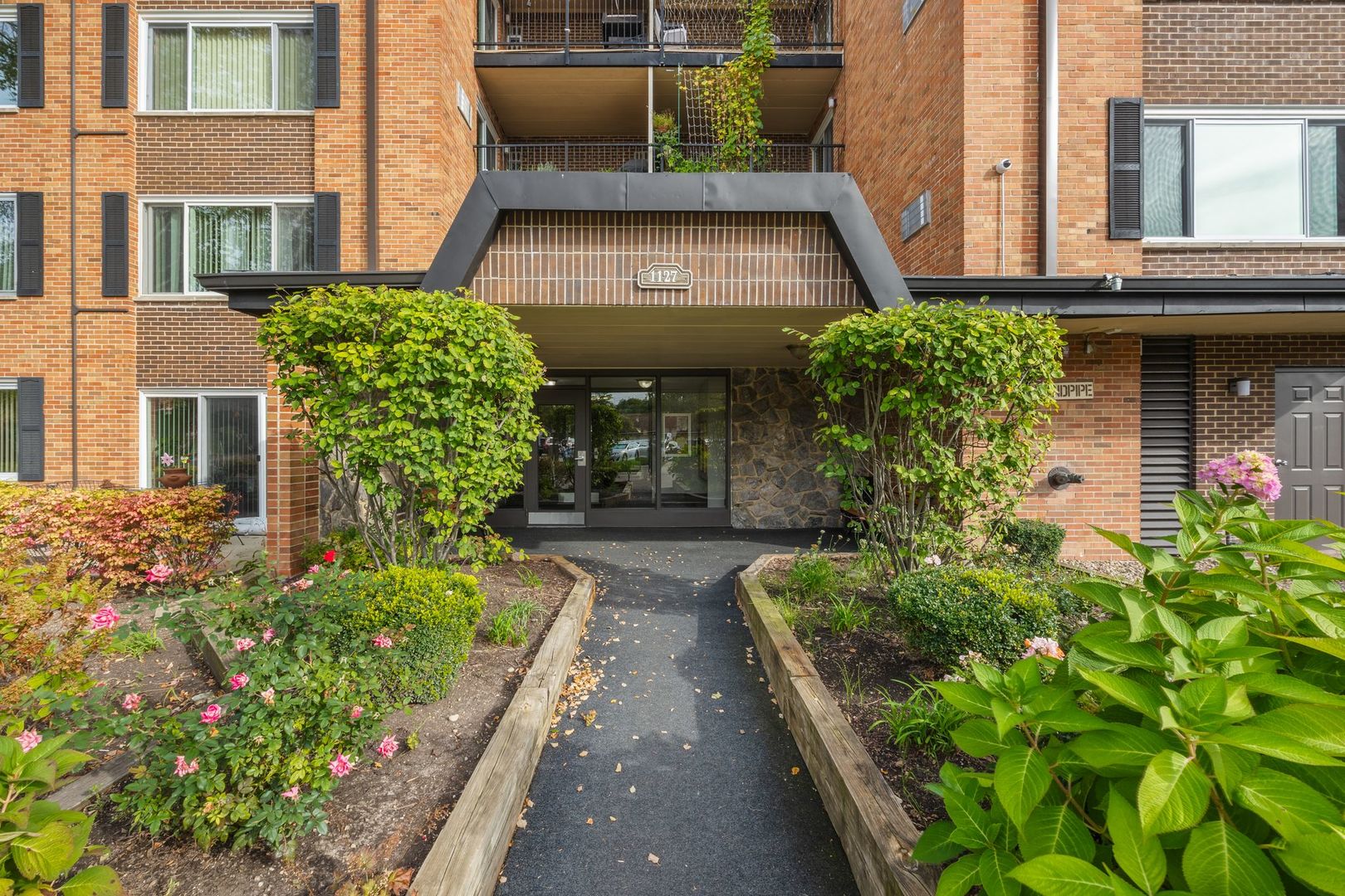 1127 South Old Wilke Road, Unit 203 Rolling Meadows, IL 60005 - Photo 2 of 13 front view of a house