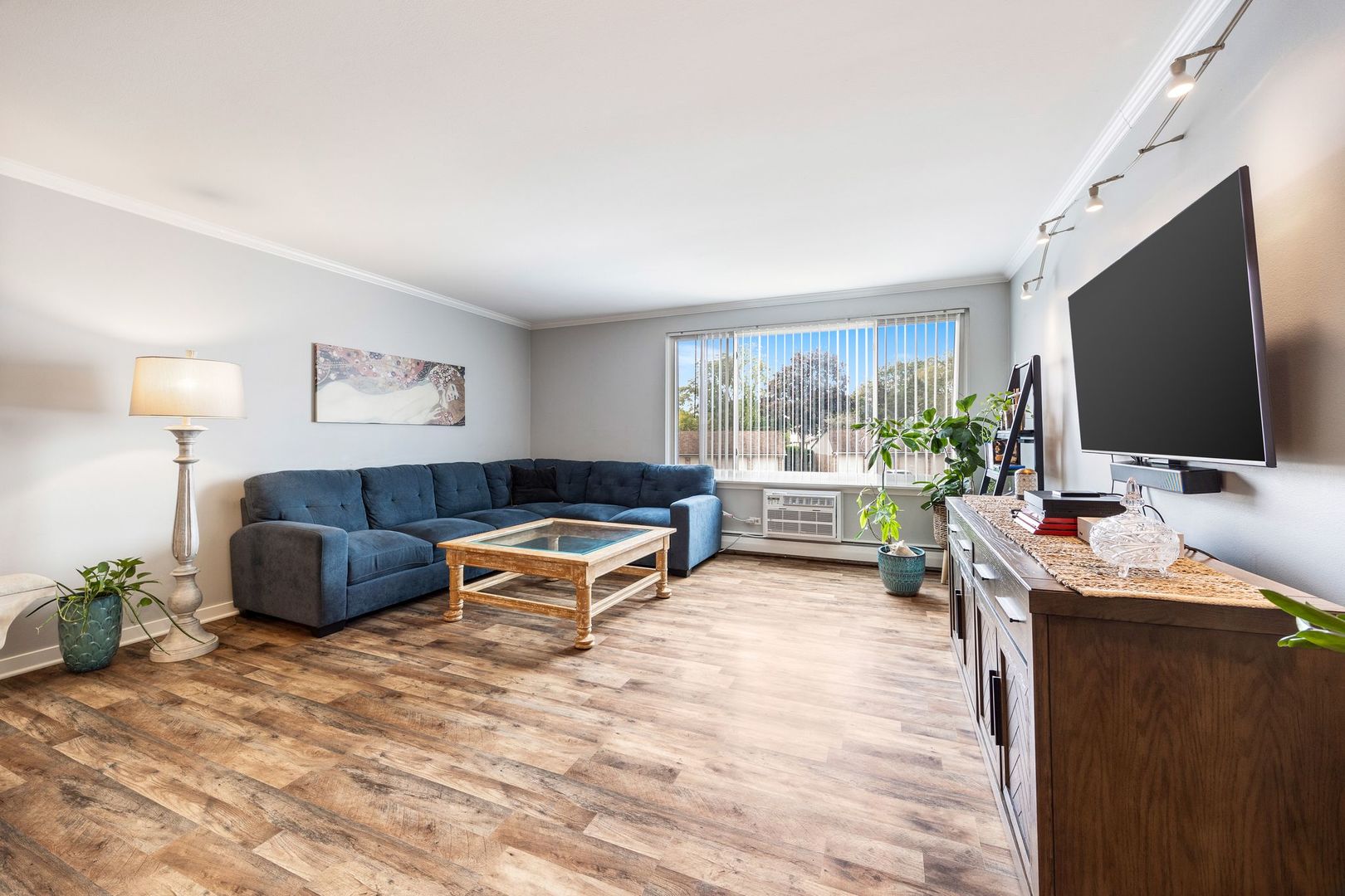1127 South Old Wilke Road, Unit 203 Rolling Meadows, IL 60005 - Photo 4 of 13 a living room with furniture and a flat screen tv