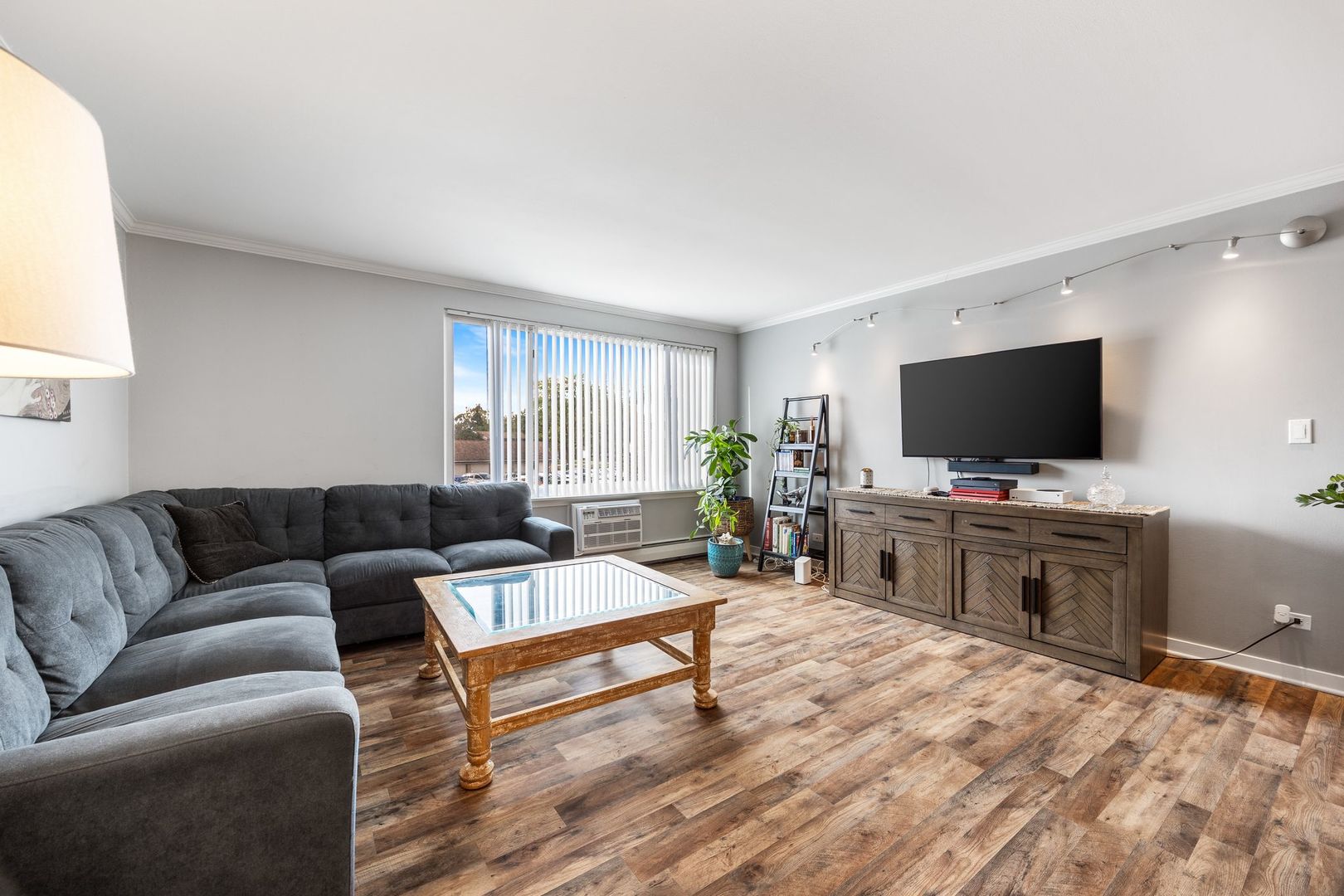 1127 South Old Wilke Road, Unit 203 Rolling Meadows, IL 60005 - Photo 5 of 13 a living room with furniture and a flat screen tv