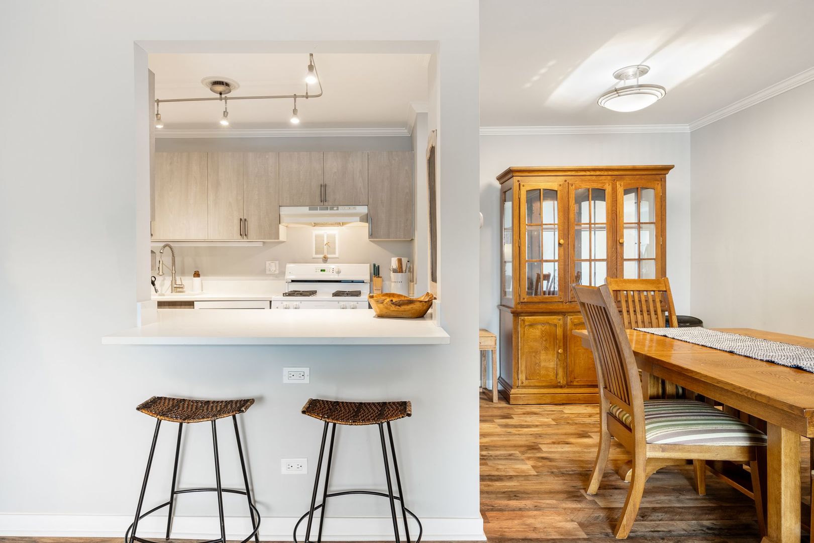 1127 South Old Wilke Road, Unit 203 Rolling Meadows, IL 60005 - Photo 7 of 13 a living room with a sink and cabinets