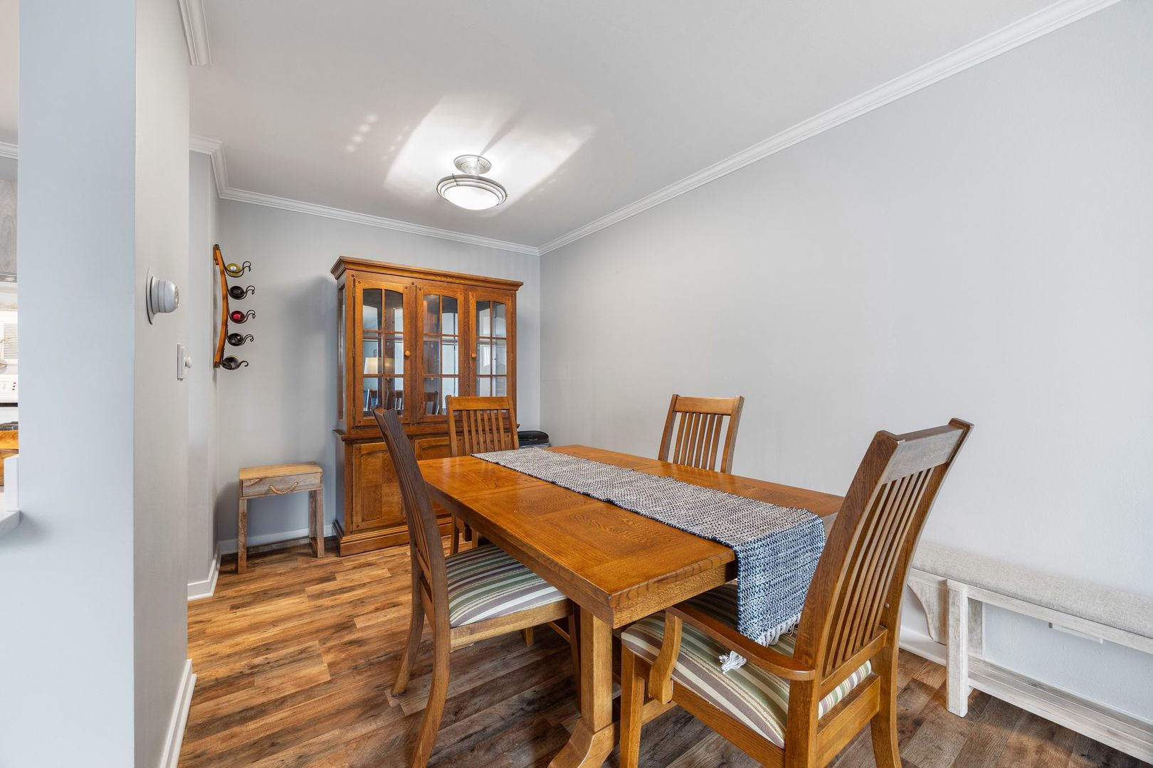 1127 South Old Wilke Road, Unit 203 Rolling Meadows, IL 60005 - Photo 8 of 13 a view of a dining room with furniture and wooden floor
