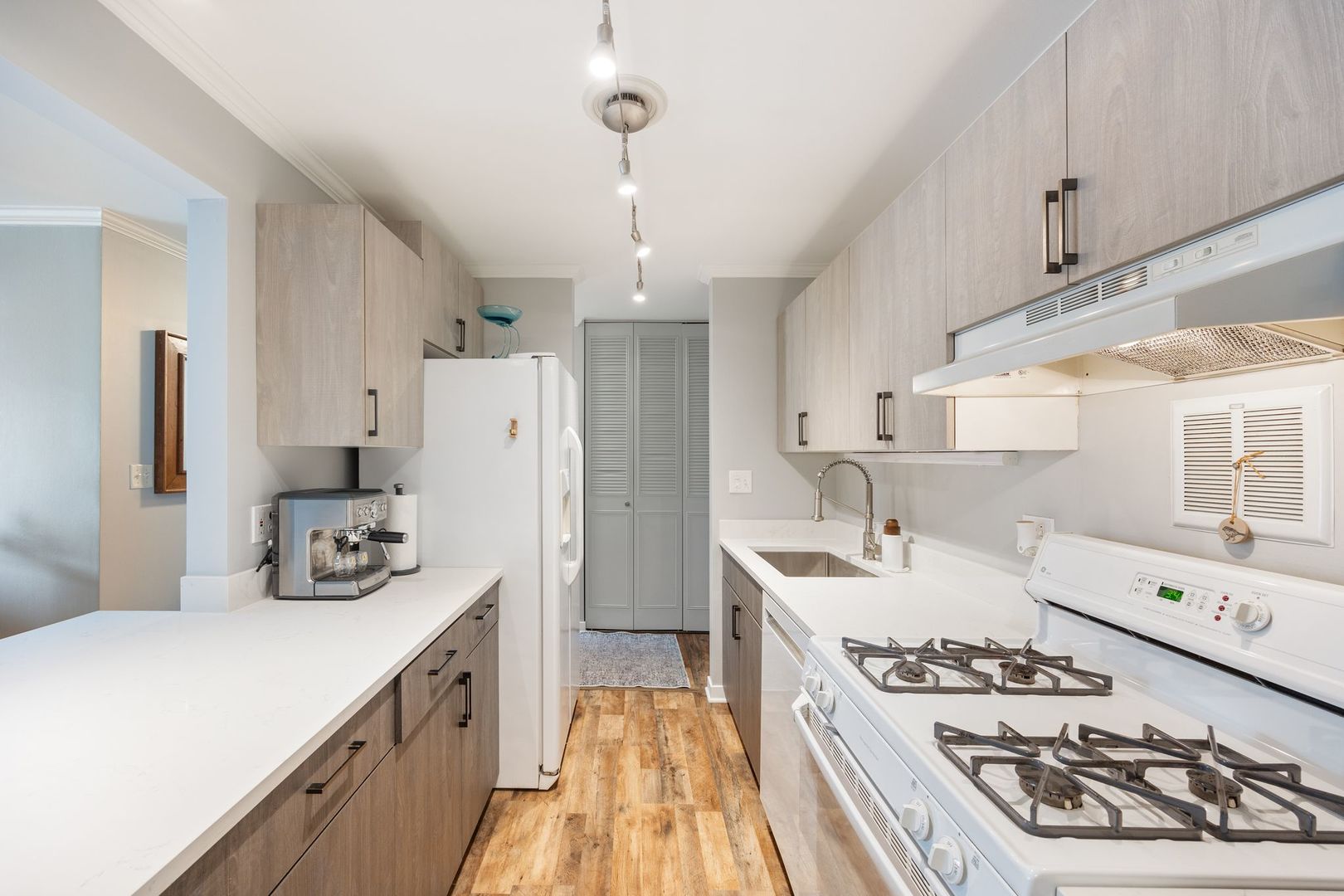 1127 South Old Wilke Road, Unit 203 Rolling Meadows, IL 60005 - Photo 9 of 13 a kitchen with stainless steel appliances a stove a sink a refrigerator and cabinets