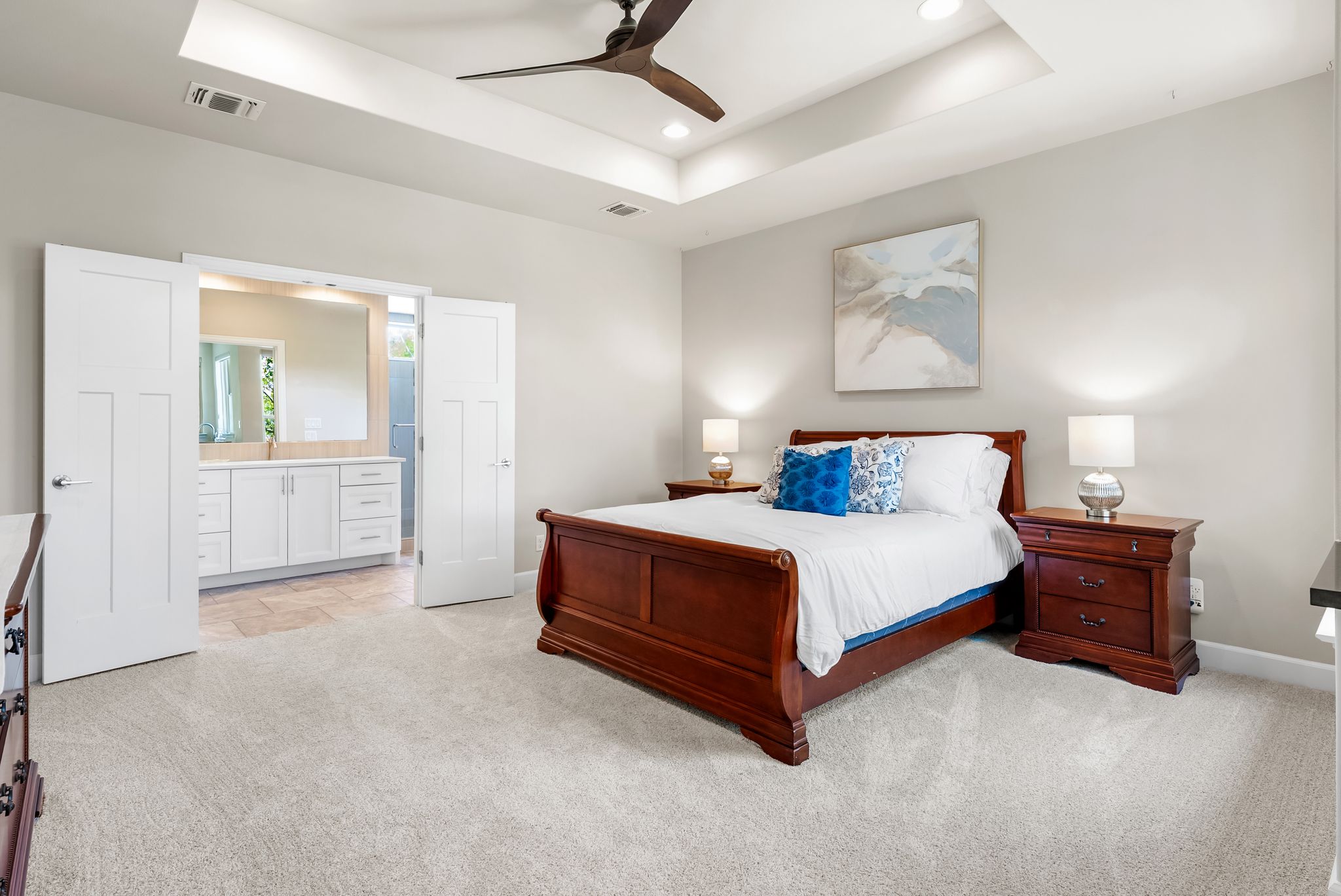 14213 Red Feather Trail Austin, TX 78734 - Photo 17 of 39 a spacious bedroom with a bed and a painting on the wall