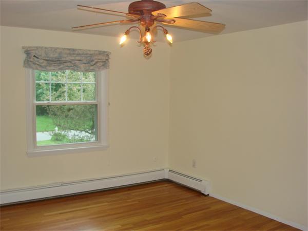 6 Buchan Road Andover, MA 01810 - Photo 5 of 12 a view of an empty room with wooden floor and a window