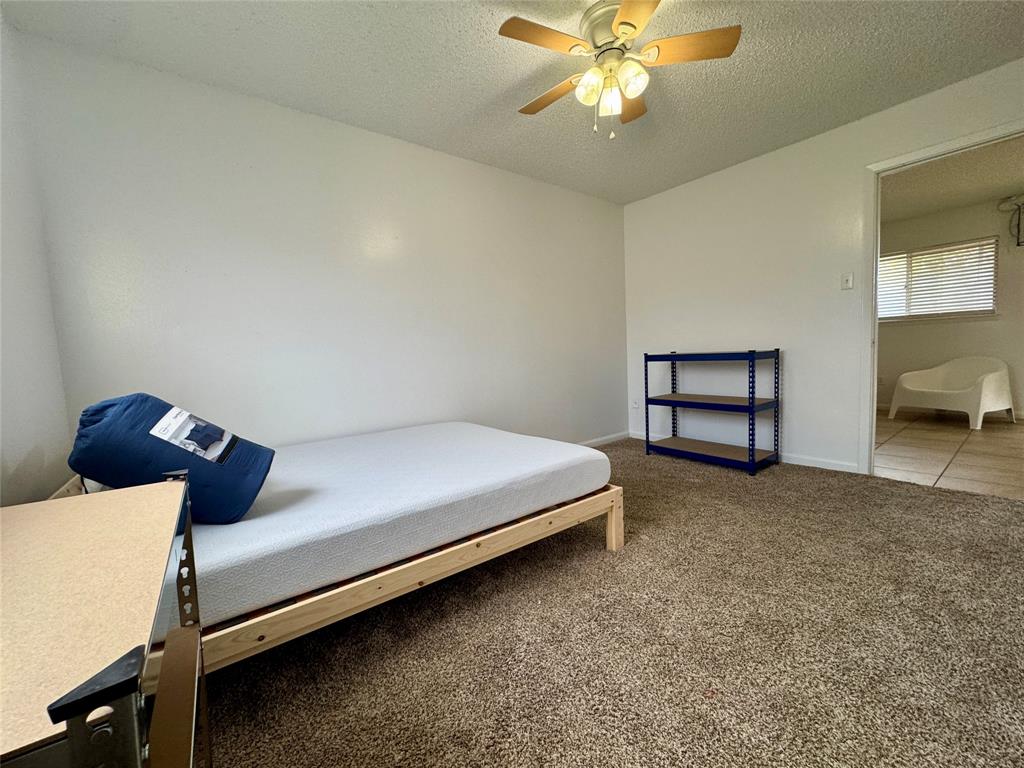 1415 Sewell Street, Unit 1 Abilene, TX 79605 - Photo 11 of 15 a bed sitting in a bedroom next to a window