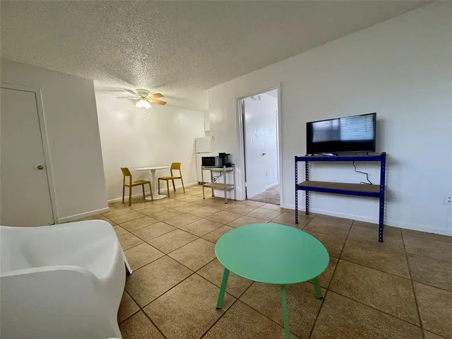 a living room with furniture and a pool table