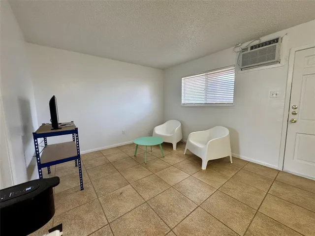 a living room with furniture a rug and a window