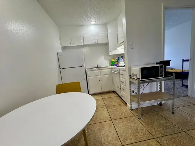 a kitchen with a cabinets and appliances