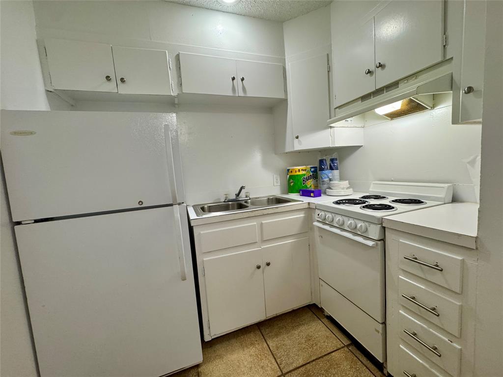 1415 Sewell Street, Unit 1 Abilene, TX 79605 - Photo 8 of 15 a kitchen with stainless steel appliances a refrigerator sink and cabinets