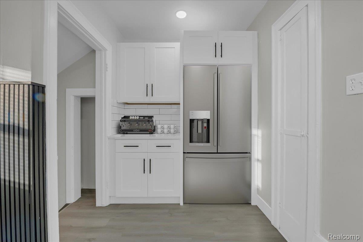 16717 Fielding Street Detroit, MI 48219 - Photo 22 of 46 Kitchen featuring white cabinetry, high end refrigerator, decorative backsplash, and light wood-type flooring