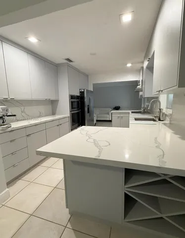 a kitchen with a sink cabinets and appliances