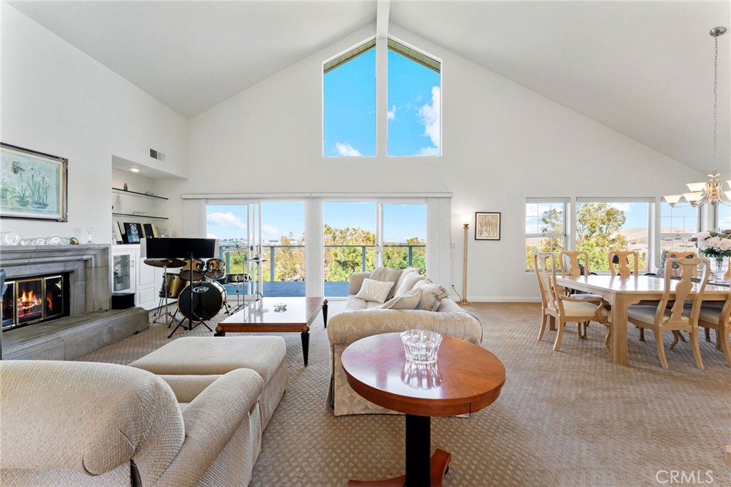 21 Centaurus Irvine, CA 92603 - Photo 11 of 65 a living room with furniture a fireplace and a large window