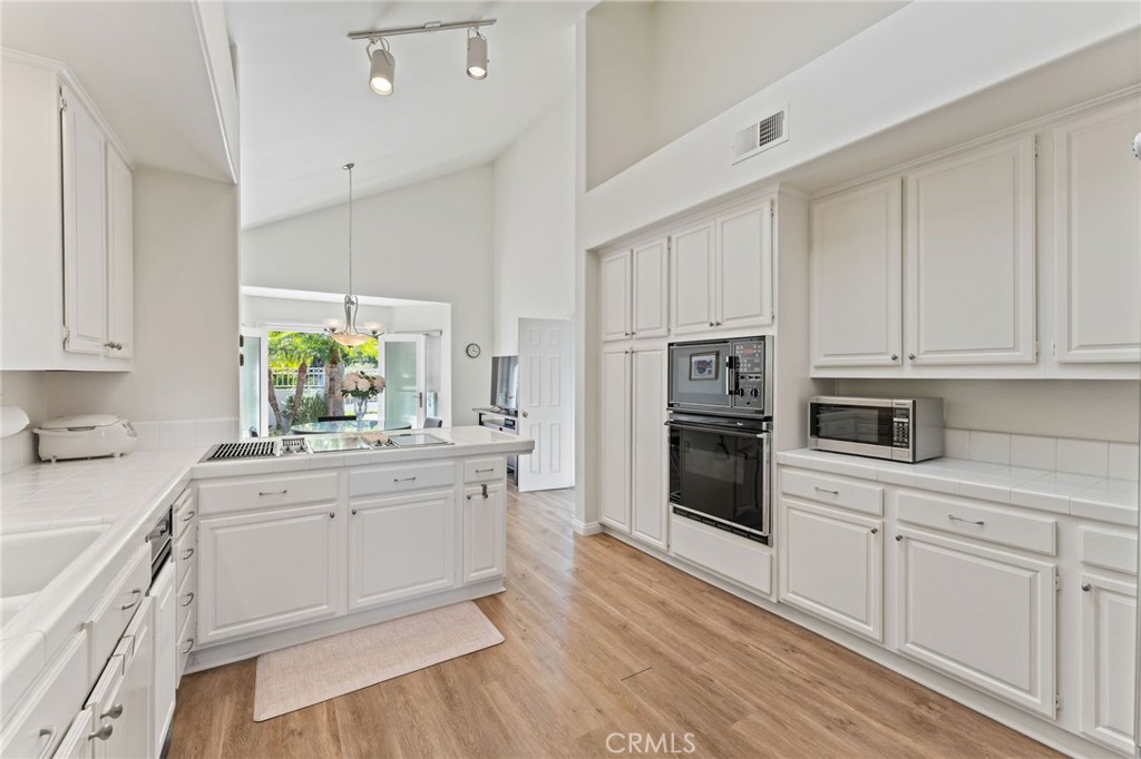 21 Centaurus Irvine, CA 92603 - Photo 18 of 65 a kitchen with a sink stove and cabinets