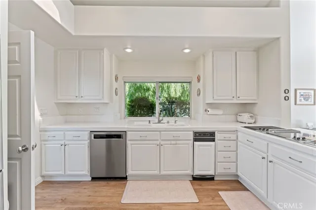 a bedroom with a bed and a flat tv screen on the dresser