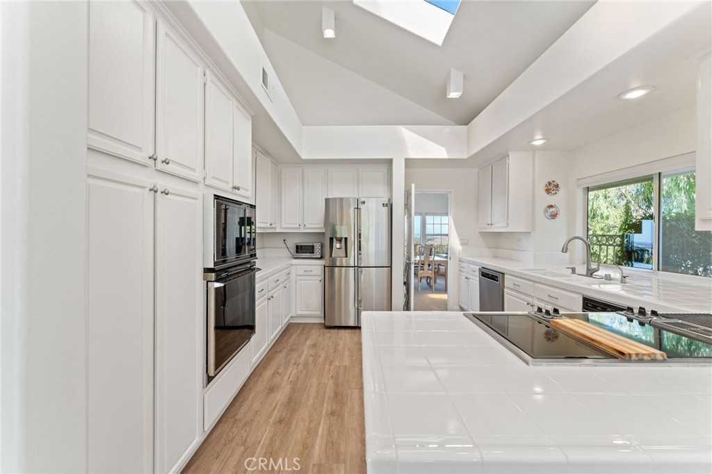 21 Centaurus Irvine, CA 92603 - Photo 20 of 65 a kitchen with stainless steel appliances a refrigerator sink and cabinets