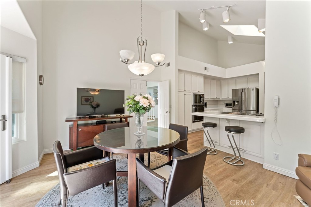 21 Centaurus Irvine, CA 92603 - Photo 22 of 65 a kitchen with a dining table cabinets and stainless steel appliances