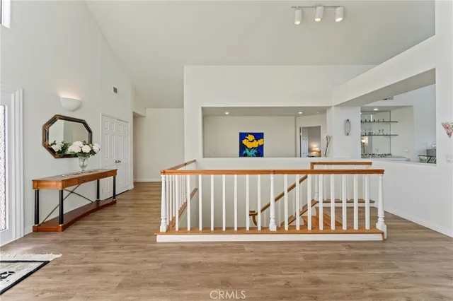 an aerial view of residential houses with outdoor space and ocean view