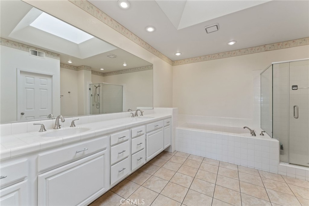 21 Centaurus Irvine, CA 92603 - Photo 32 of 65 a spacious bathroom with a double vanity sink a mirror and a bathtub