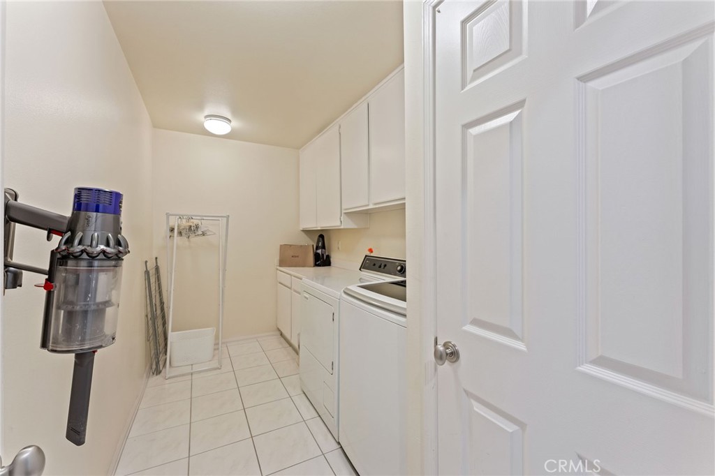 21 Centaurus Irvine, CA 92603 - Photo 47 of 65 a kitchen with white cabinets and white appliances