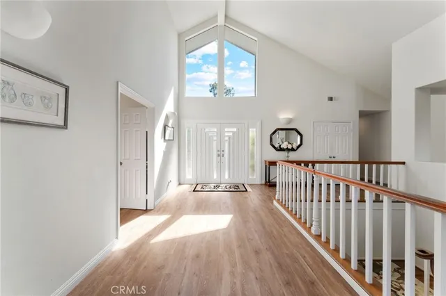 a dining room with furniture a chandelier and window