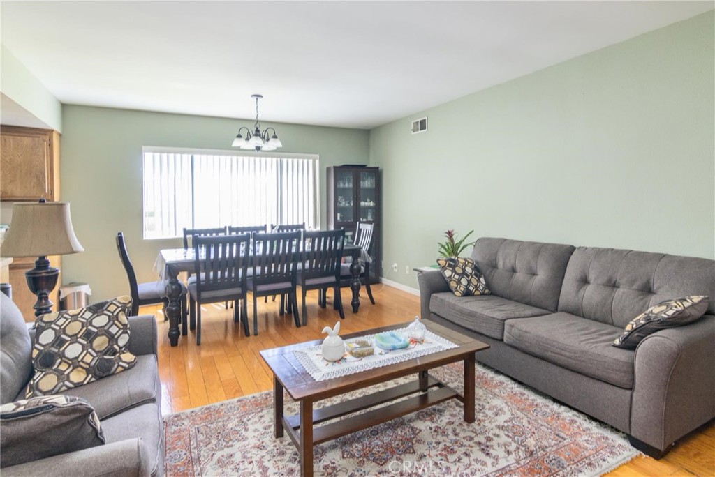 1031 Irving Avenue Glendale, CA 91201 - Photo 6 of 11 a living room with furniture and a chandelier
