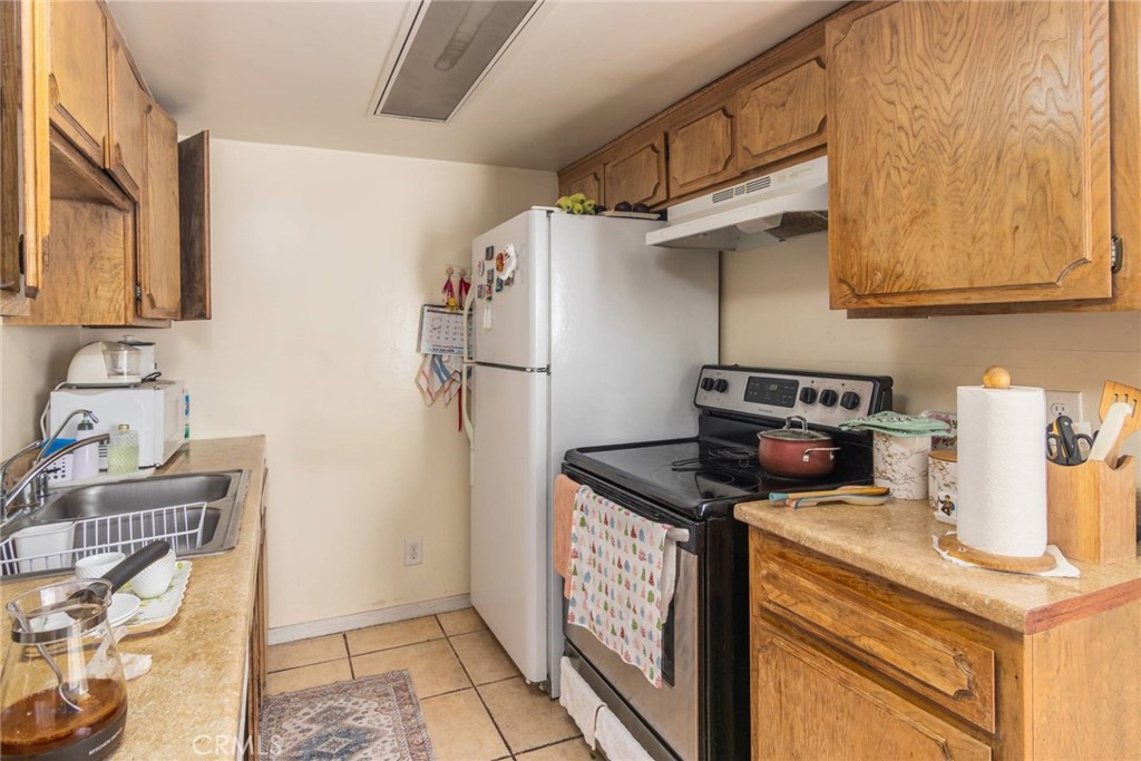 1031 Irving Avenue Glendale, CA 91201 - Photo 8 of 11 a kitchen with stainless steel appliances granite countertop a sink stove and refrigerator