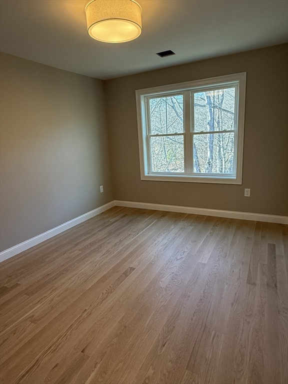 10 Muriel Way Rehoboth, MA 02769 - Photo 15 of 40 an empty room with wooden floor and windows