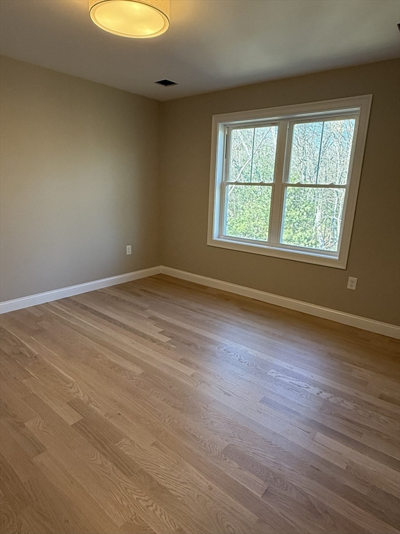 10 Muriel Way Rehoboth, MA 02769 - Photo 19 of 40 an empty room with wooden floor and windows