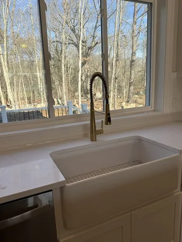 a bathroom with a sink mirror and toilet