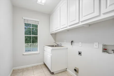 a utility room with cabinets washer and dryer