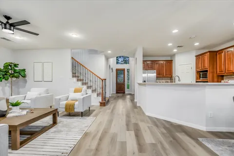 a living room with furniture and a kitchen view