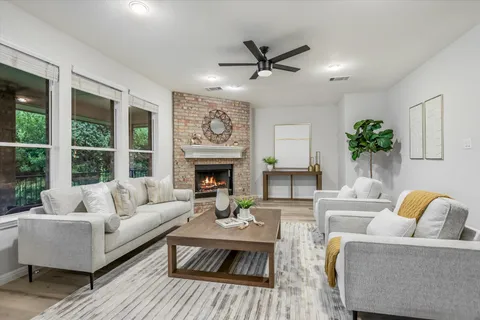 a living room with furniture and a fireplace