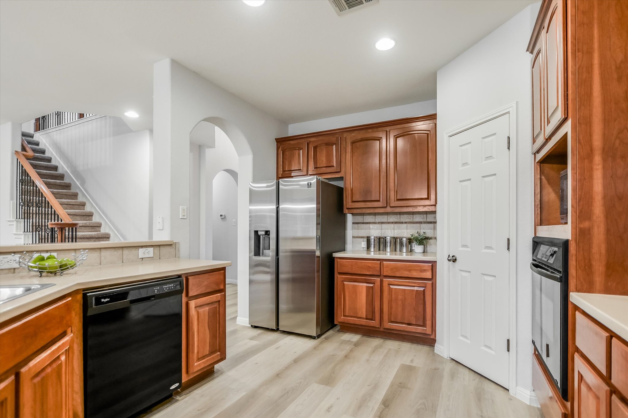 9409 Lisi Anne Drive Austin, TX 78717 - Photo 9 of 25 a kitchen with stainless steel appliances granite countertop a refrigerator a stove and a sink with wooden floors