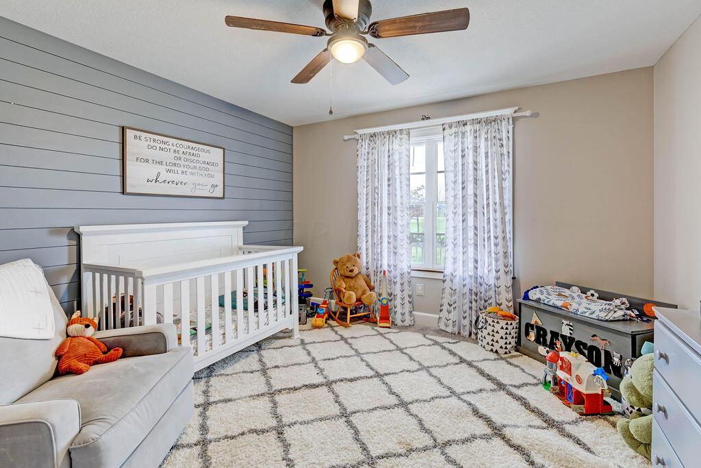 4045 Russell Road Mount Gilead, OH 43338 - Photo 28 of 74 • New gray carpet • Tan painted walls & gray shiplap wall • Walk-in closet • Lighted ceiling fan