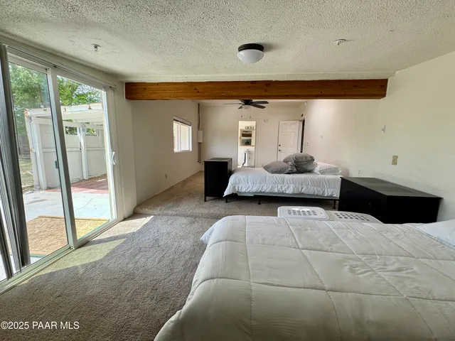 a living room with furniture and large windows