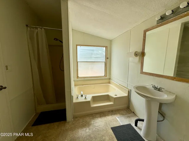 a bathroom with a sink a toilet and tub